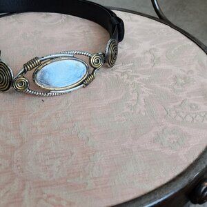 Black belt with unique front that hooks and oval area is brushed metal